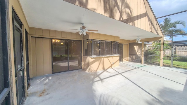 view of patio / terrace featuring ceiling fan and glass enclosure