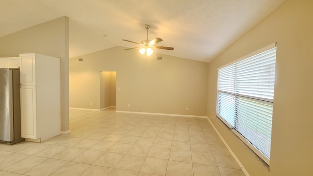 tiled spare room with high vaulted ceiling and ceiling fan