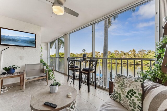 balcony featuring a water view and ceiling fan