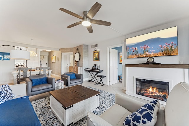 tiled living room featuring ceiling fan