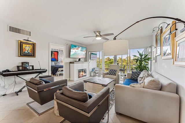 living room featuring ceiling fan and light tile patterned floors