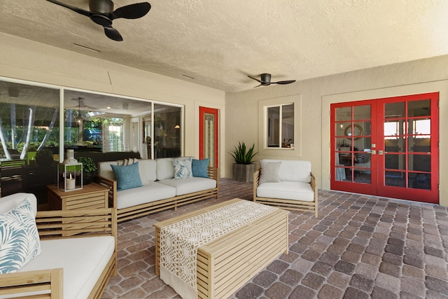 view of patio / terrace with an outdoor living space, ceiling fan, and french doors