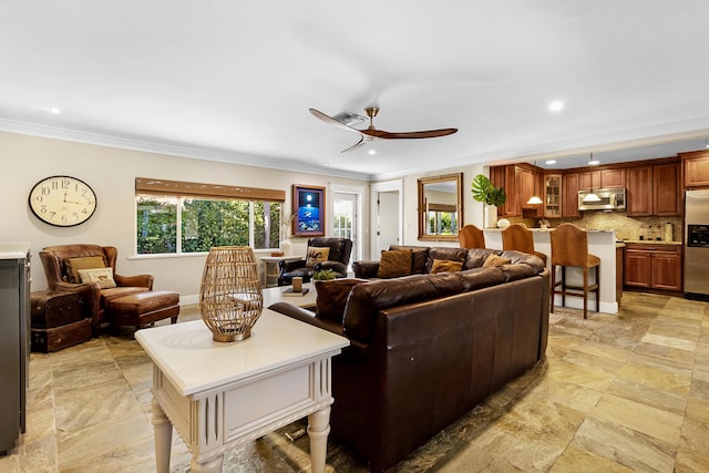 living room featuring ceiling fan and ornamental molding