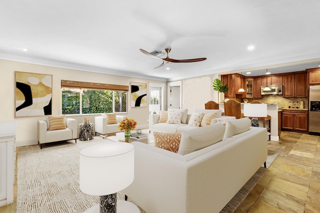 living room featuring ceiling fan and crown molding