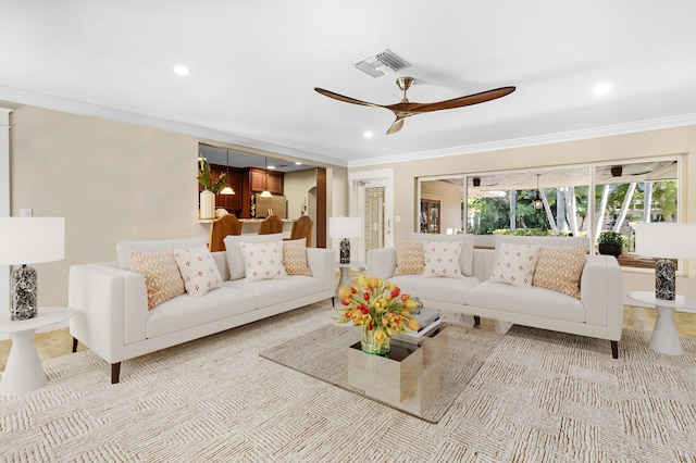 living room featuring ceiling fan and crown molding