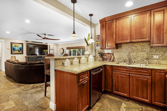 kitchen featuring kitchen peninsula, light stone counters, a breakfast bar area, and sink