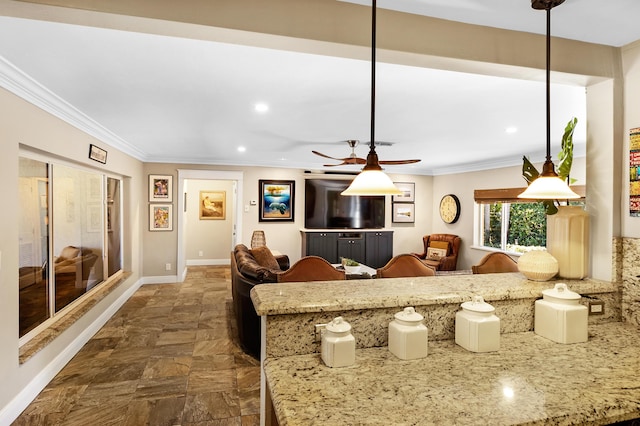 kitchen with decorative light fixtures, ceiling fan, and crown molding