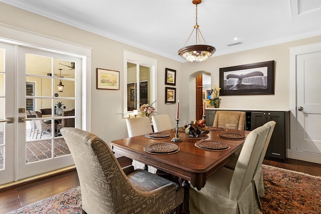 dining space featuring dark hardwood / wood-style floors and crown molding