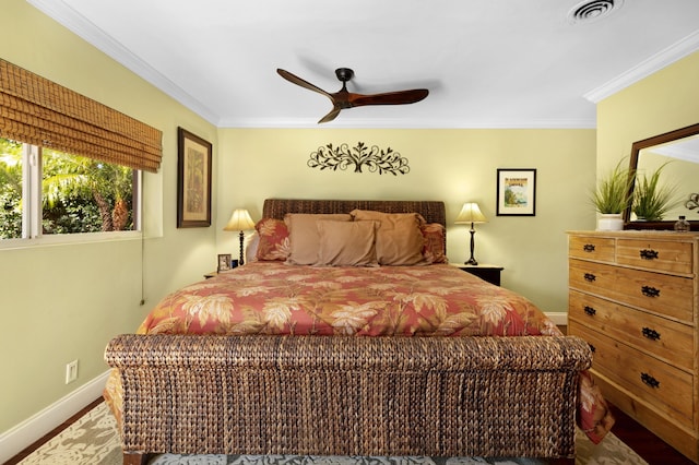 bedroom with hardwood / wood-style floors, ceiling fan, and crown molding