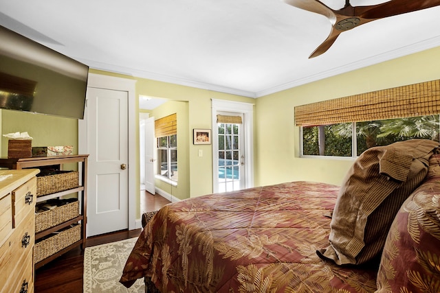 bedroom with access to exterior, dark hardwood / wood-style floors, ceiling fan, and crown molding