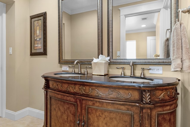 bathroom featuring tile patterned flooring, vanity, and crown molding