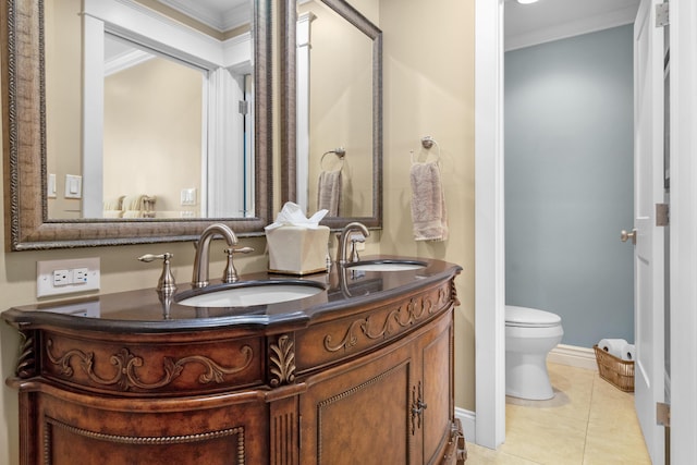 bathroom featuring tile patterned floors, crown molding, vanity, and toilet