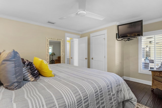 bedroom with dark hardwood / wood-style flooring, ceiling fan, and ornamental molding