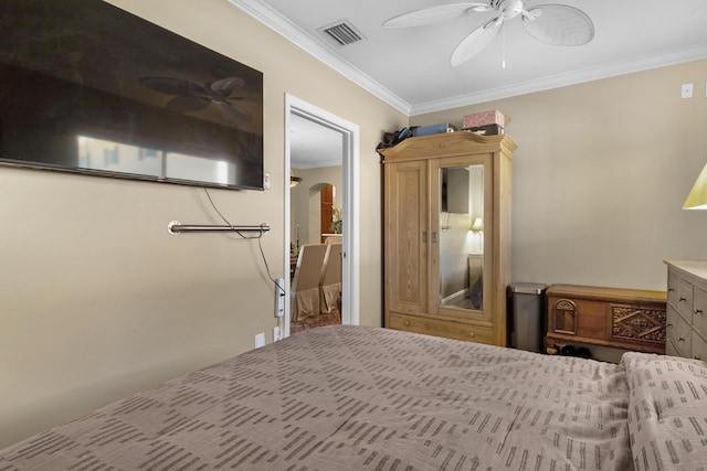 bedroom featuring ceiling fan and crown molding