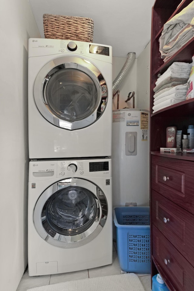 laundry area with light tile patterned floors and stacked washer and clothes dryer