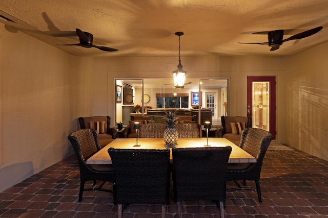 dining room featuring a textured ceiling and ceiling fan