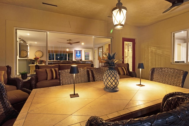 dining area featuring a textured ceiling and ceiling fan