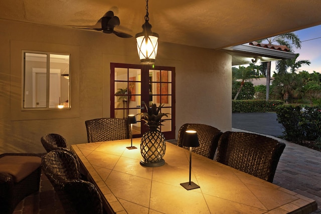 dining area featuring ceiling fan, a textured ceiling, and french doors