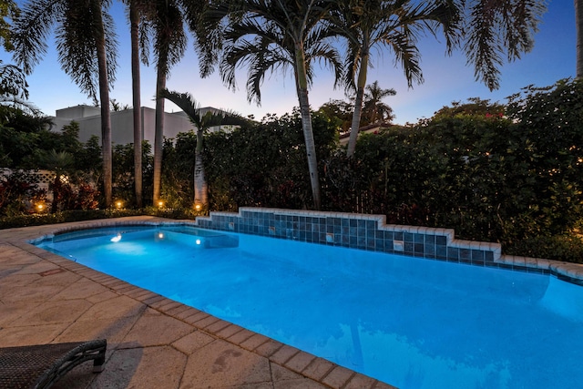 view of pool at dusk