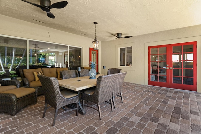 view of patio / terrace with an outdoor living space, ceiling fan, and french doors