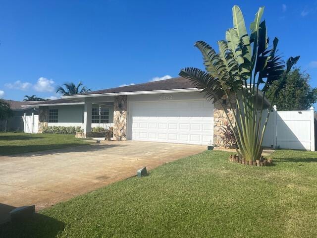 single story home featuring a front lawn and a garage