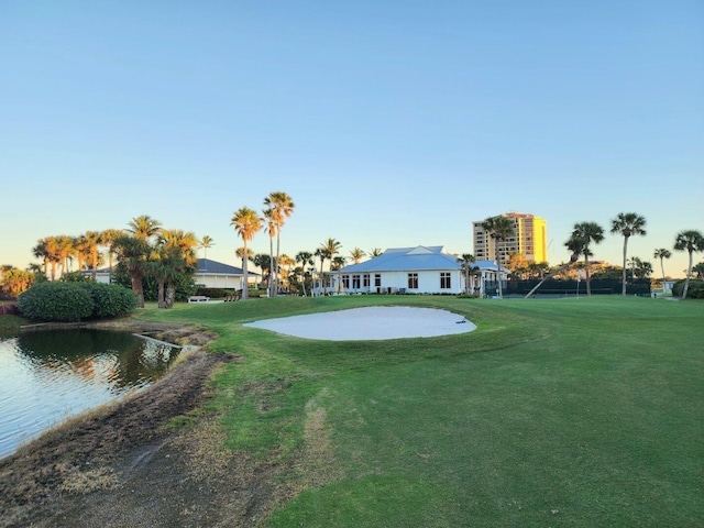 view of home's community with a yard and a water view