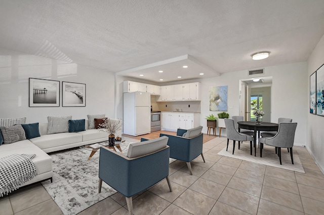 living room with light tile patterned floors and a textured ceiling