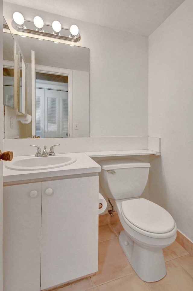 bathroom with tile patterned floors, vanity, and toilet