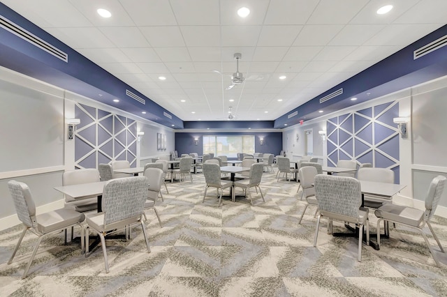 dining area featuring carpet and ceiling fan