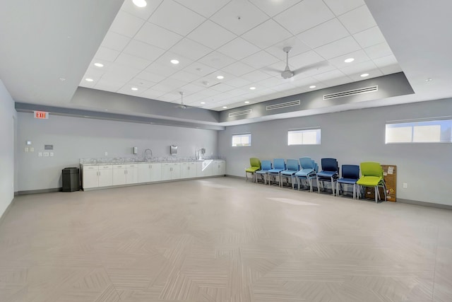 interior space featuring ceiling fan and sink