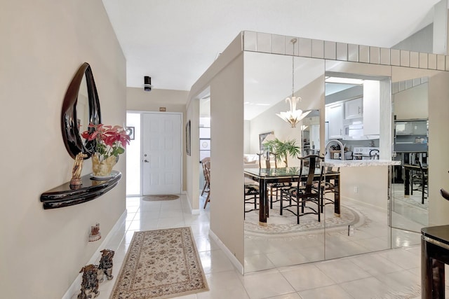 dining area with light tile patterned flooring and an inviting chandelier