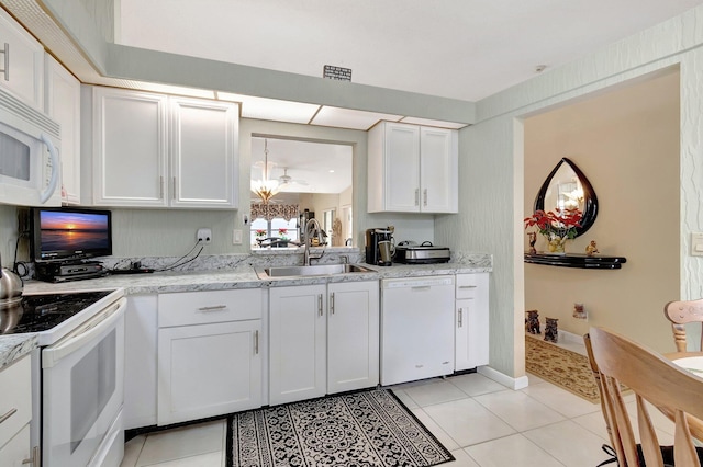 kitchen featuring white cabinetry, white appliances, sink, and light tile patterned floors