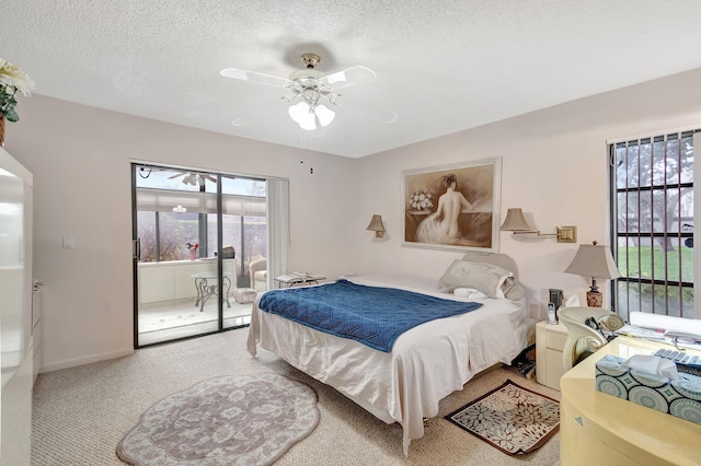 carpeted bedroom with a textured ceiling and ceiling fan