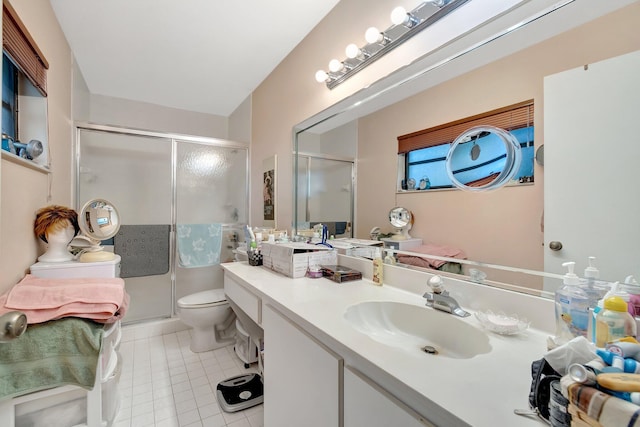 bathroom with vanity, toilet, and a shower with shower door