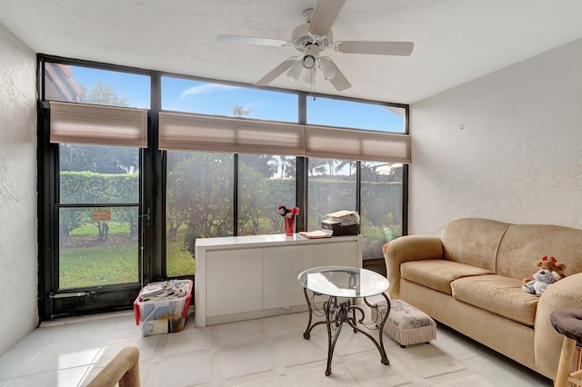 sunroom / solarium featuring ceiling fan