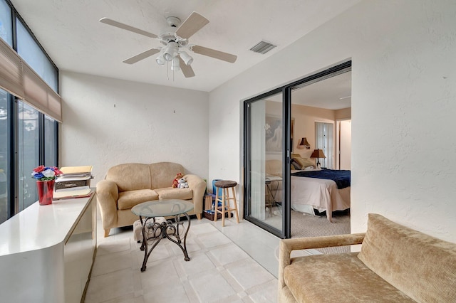 tiled living room featuring ceiling fan