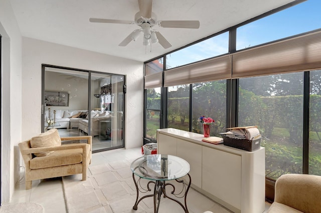 sunroom / solarium featuring ceiling fan