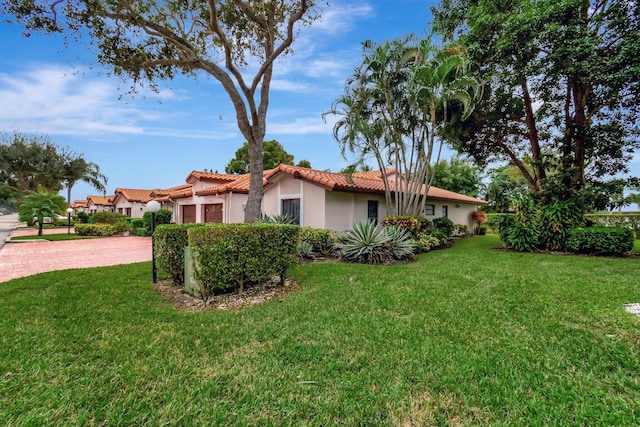 view of side of home with a lawn