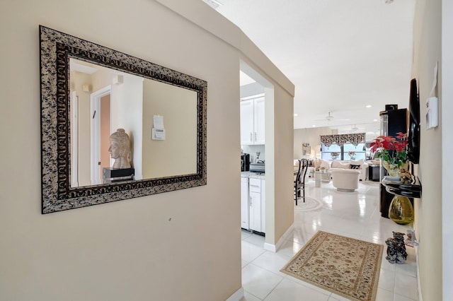 hall with light tile patterned floors