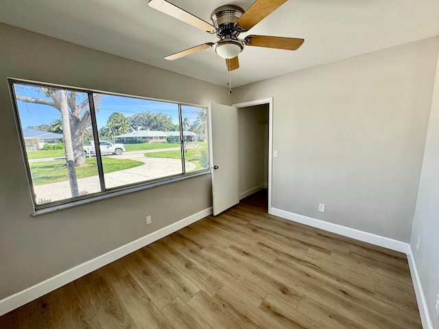 spare room featuring light wood-type flooring and ceiling fan