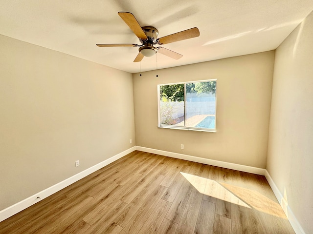 spare room with light hardwood / wood-style floors and ceiling fan