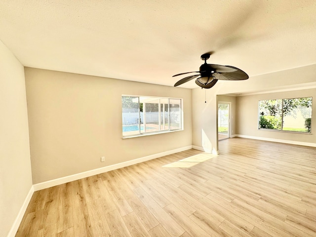 spare room featuring ceiling fan, a textured ceiling, and light hardwood / wood-style flooring