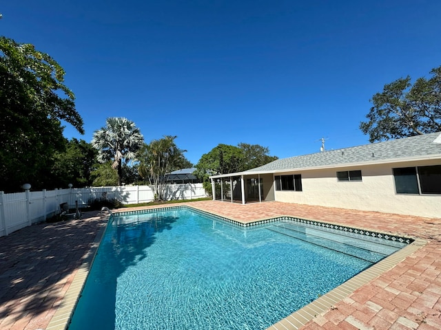 view of swimming pool featuring a sunroom