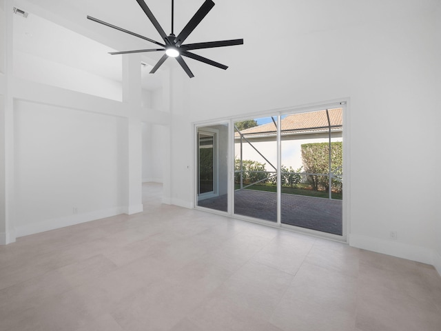 unfurnished living room with a high ceiling and ceiling fan