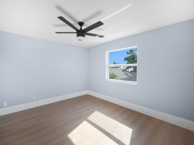 spare room with ceiling fan and wood-type flooring