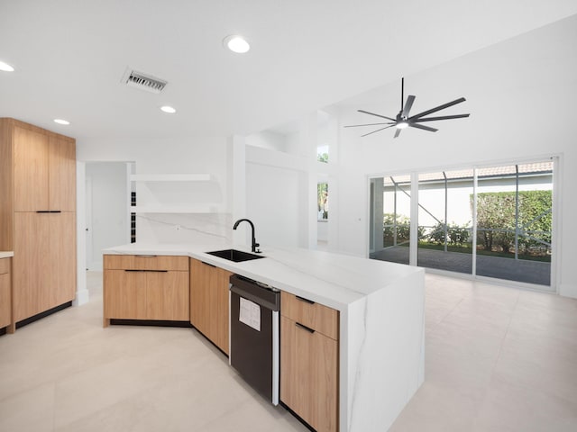 kitchen with kitchen peninsula, light stone countertops, stainless steel dishwasher, ceiling fan, and sink