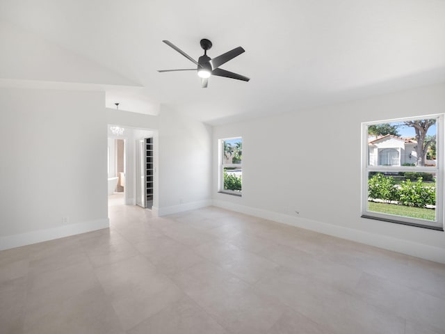 spare room featuring a wealth of natural light, ceiling fan, and lofted ceiling