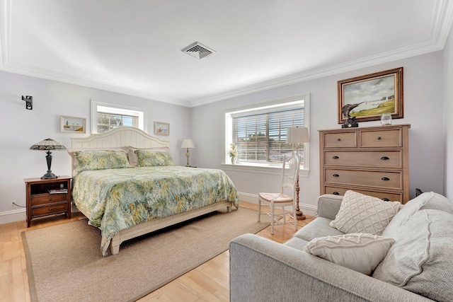 bedroom featuring multiple windows, crown molding, and light hardwood / wood-style floors