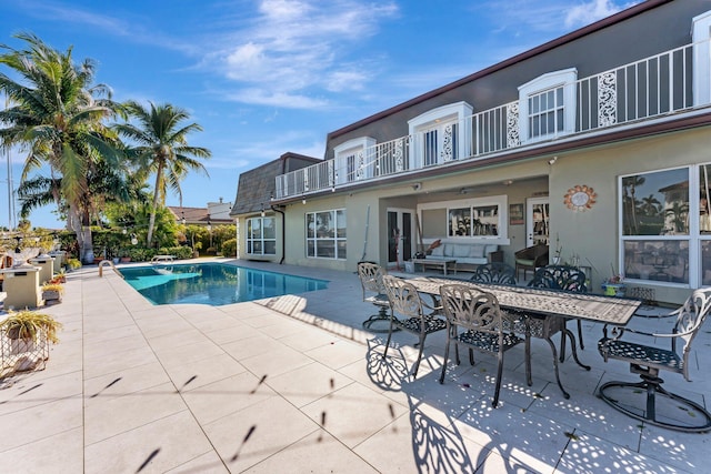 view of pool with outdoor lounge area and a patio