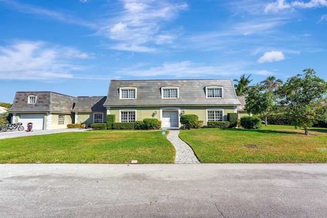 view of front of house featuring a front yard and a garage